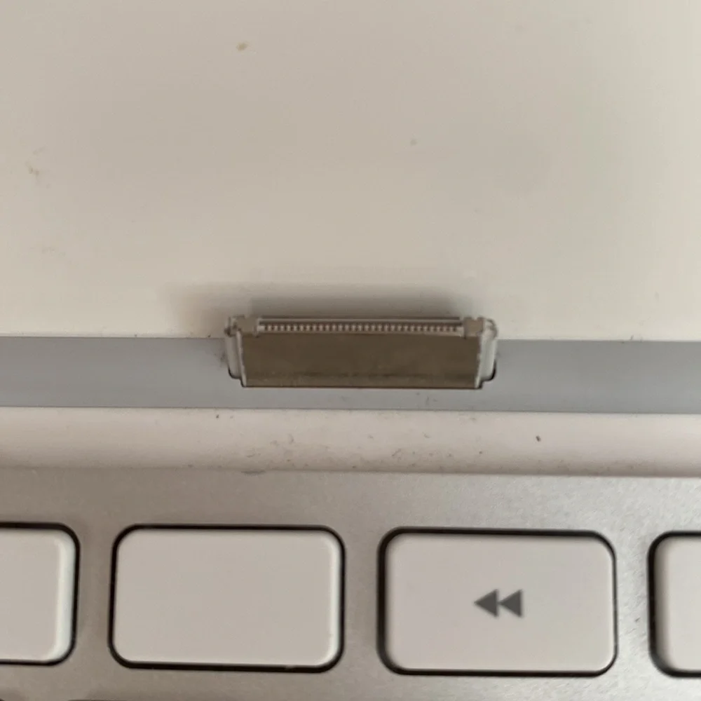 A New in Box original iPad keyboard. It has the original connector, though